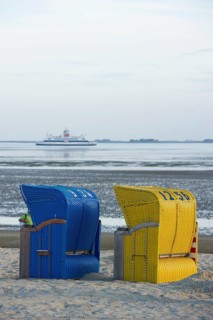Colourful roofed wicker beach chairs on the beach near Wyk