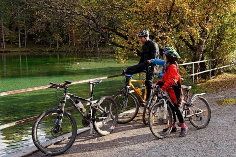 Father and children riding mountain bikes