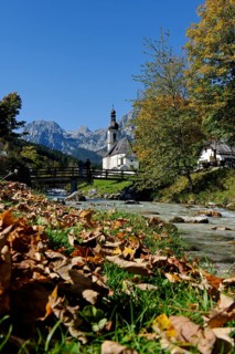 Parish Church of Saint Sebastian and the Ramsau river in front of the Reiteralpe or Reiter Alm mountains