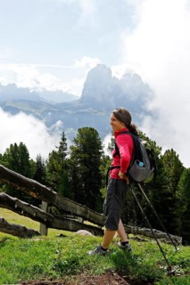 Hiker at the Raschotz or Rasciesa mountain pasture with Mt. Sasso Lungo