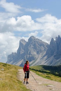 Hiker at the Raschötz or Rasciesa mountain pasture with the Odle group