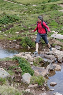 Hiker at the Raschotz or Rasciesa mountain pasture near St. Ulrich