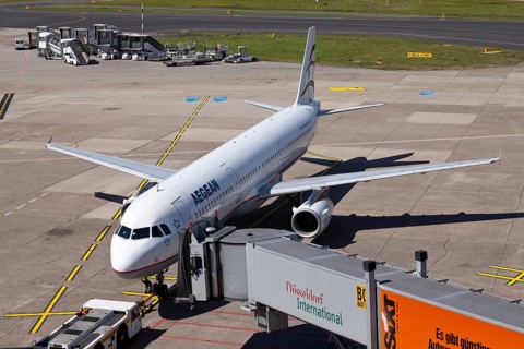 AegeanAir SX-DGA Airbus A 321-232 aircraft being attached to a jetway or passenger boarding bridge on the airport apron