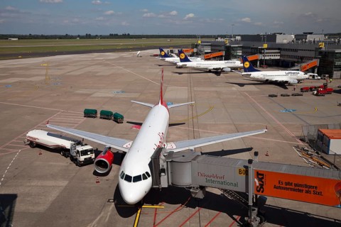 Airplane attached to a jetway or passenger boarding bridge on the airport apron