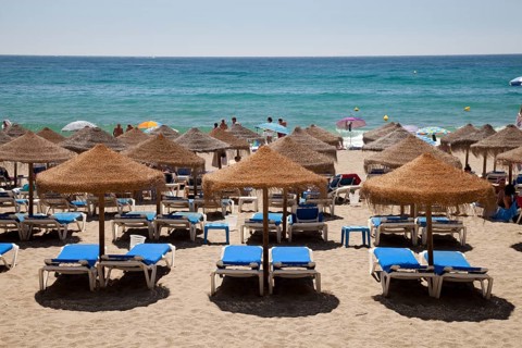 Sun beds and umbrellas on the sandy beach