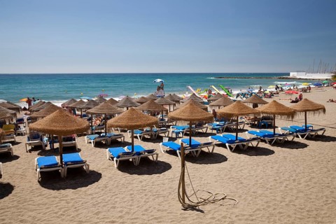 Sun beds and umbrellas on the sandy beach