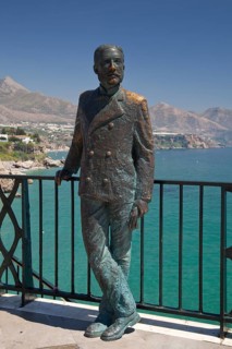 Statue of El Rey Alfonso XII on the observation deck of Balcon de Europa overlooking the beach and coast in Nerja