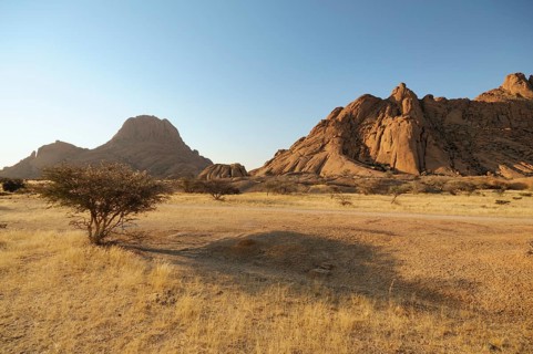 Savannah landscape with granite rocks of Spitzkoppe Mountain and the Pontok Mountains