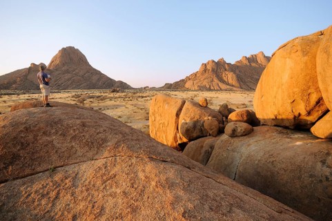 Savannah landscape in the evening sun with rock formations