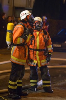 Two firefighters on site at an apartment fire