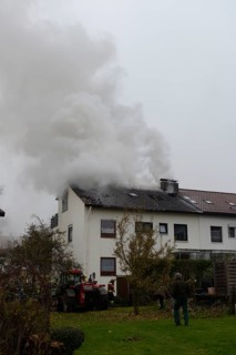 Thick smoke escaping from the roof during a roof fire