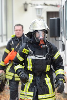 Firefighter wearing breathing equipment during a roof fire
