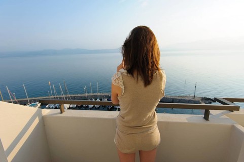 Young woman standing on a balcony