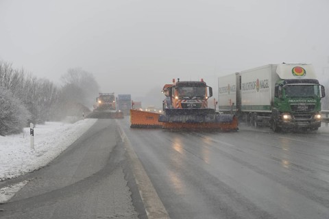 Snow-clearing vehicle from the motorway maintenance authorities in operation on the A8 motorway