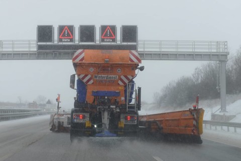 Snow-clearing vehicle from the motorway maintenance authorities in operation on the A8 motorway