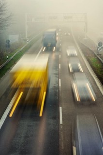Rush hour on a motorway with early morning fog