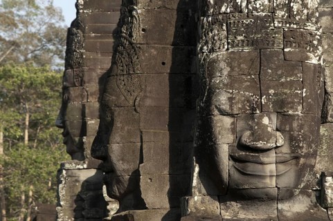 Large sculptures of heads on tower of Khmer temple