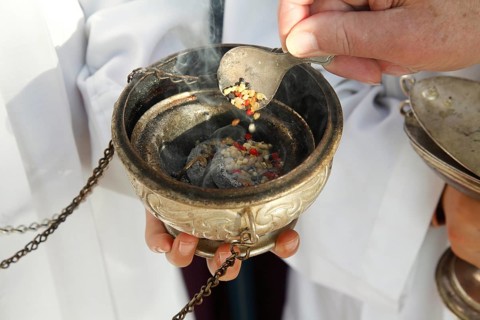 Frankincense being scattered in a censer