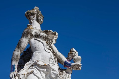 Baroque statue wearing a hand knitted wrist warmer in front of the Electoral Palace in Trier