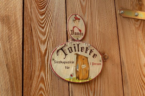 Sign toilet men at wooden door