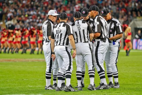 The referee crew discusses a ruling during the NFL International game between the Tampa Bay Buccaneers and the Chicago Bears on October 23