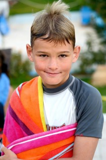 9-year-old boy with wet hair and a towel