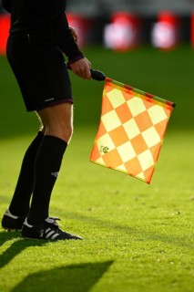 Linesman holding a flag with backlighting