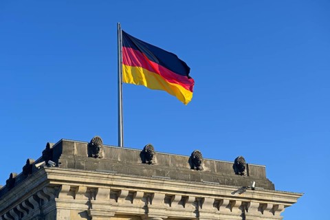 German flag on one of the towers of the Reichstag building