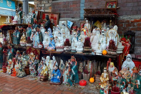 Adoration figures with incense on a small altar in the street