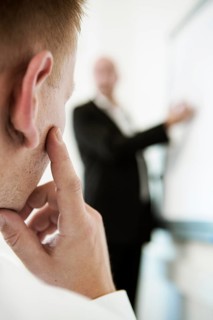 Speaker explaining something on a flip for his audience during a training