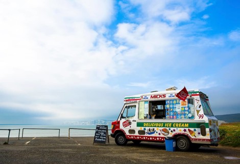 An ice cream van is parked on a coastal car park above Compton Bay on the Isle of Wight