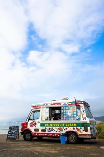 An ice cream van is parked on a coastal car park above Compton Bay on the Isle of Wight