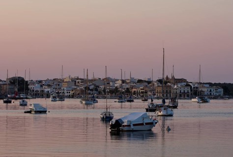 Sailing boats in a harbour at sunset