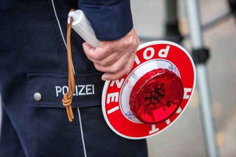 Policeman holding a signalling disc
