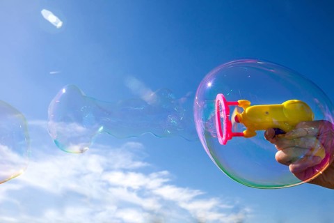 Smaller soap bubbles enclosed in larger bubbles from a bubble machine