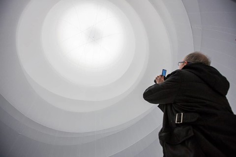 Visitor taking a picture of an installation by Christo