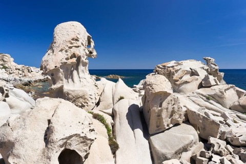Eroded granite rocks on the beach of Punta Molentis