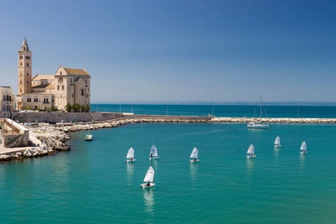 Sailing school in the harbor with Trani Cathedral