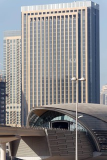 Jumeirah Lake Towers Metro Station in front of a skyscraper