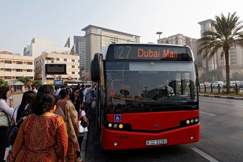 People getting on a bus to Dubai Mall