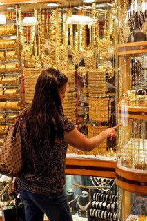 Woman looking at gold jewellery in a shop window