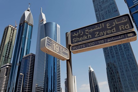 Street sign for Sheikh Zayed Road in front of skyscrapers