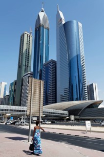Single pedestrian in front of skyscrapers