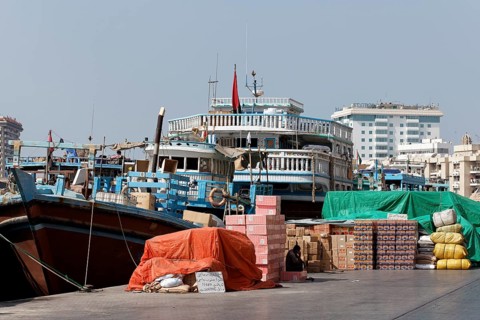 Cargo in front of an old wooden cargo ship