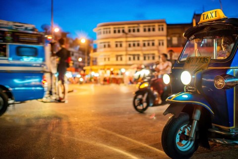 A tuktuk at a busy intersection at the Waraort Market in Chiang Mai