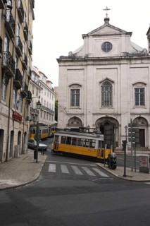 Three trams near a church
