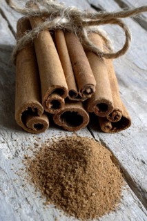 Cinnamon sticks and ground cinnamon on wooden boards