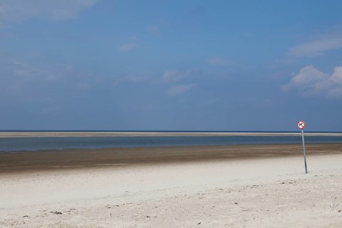 Deserted beach with a dogs prohibition sign on the island of Langeoog