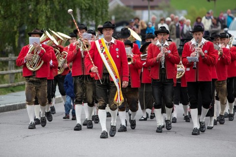 The Weissensee marching band in traditional costumes performing at the Naturparkfest festival in Techendorf