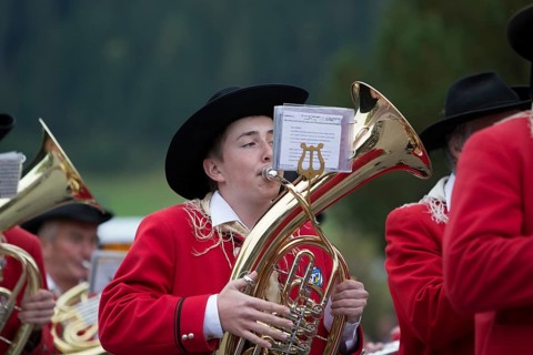 Brass player of the Weissensee marching band in traditional costume performing at the Naturparkfest festival in Techendorf